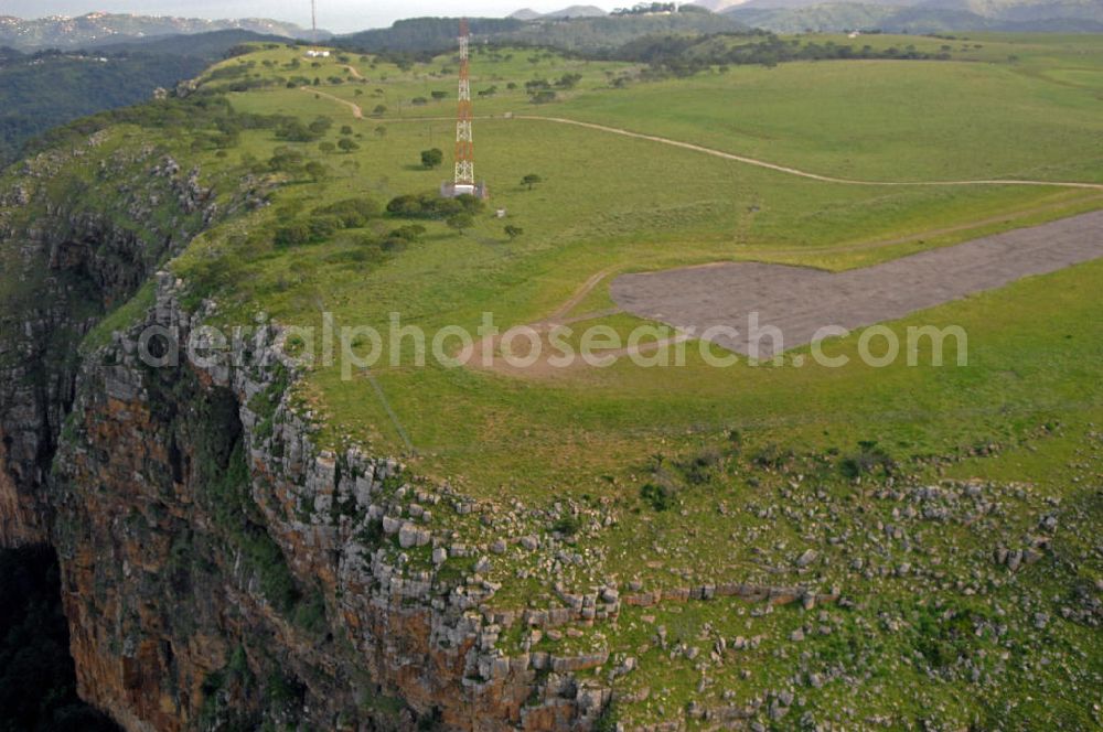 Aerial image Port St. Johns - Die Start- und Landebahn des Flughafens Port St. Johns auf dem Gipfel der nahegelegenen Sandsteinberge. The runway of the airport Port St. Johns on the summit of the nearby sandstone hills.