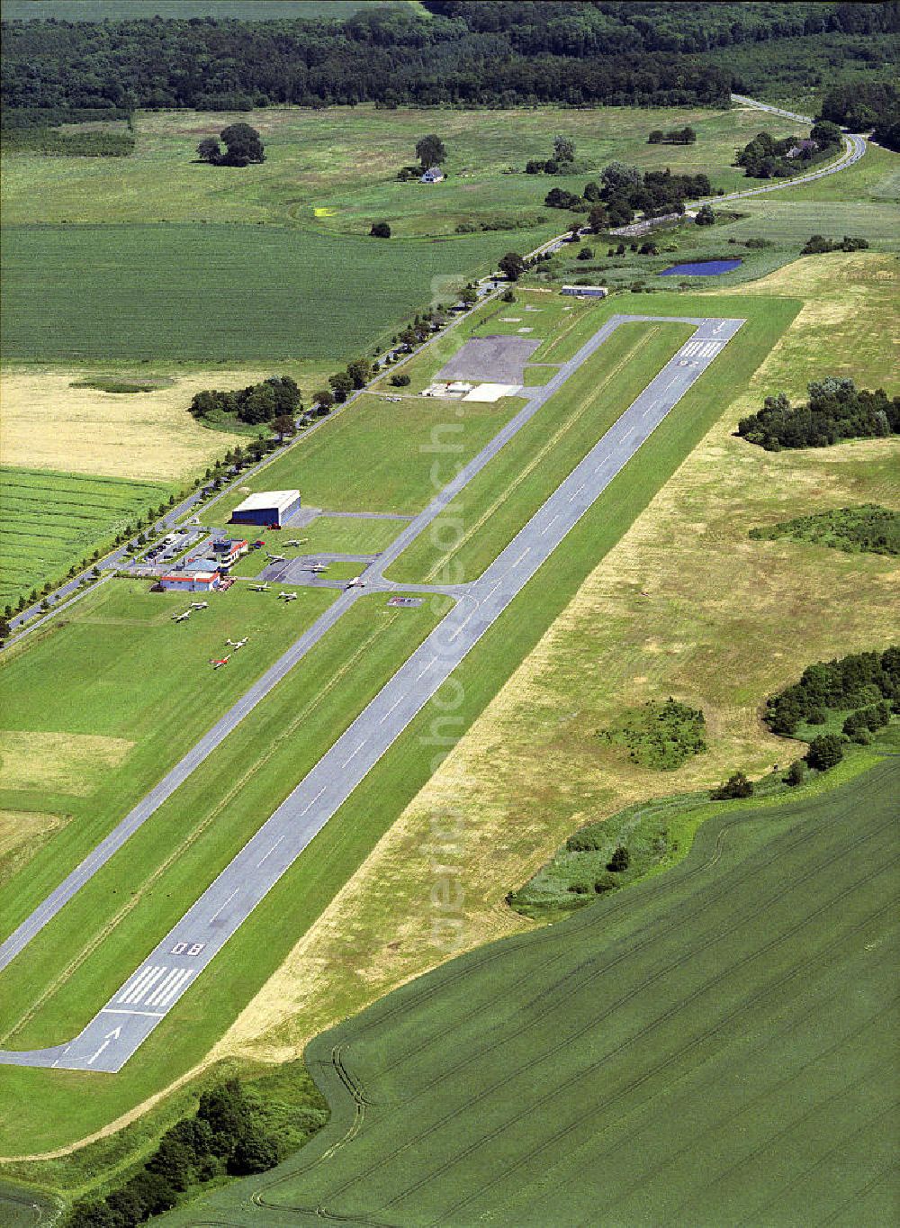 Güttin from the bird's eye view: Blick auf den Flugplatz Rügen - Güttin, einem ehemaligen DDR-Agrarflugplatz mit 2009 ausgebauter Piste, dem einzigen Flugplatz auf der Ostsee- Insel. View of the airfield Rügen - Güttin, a former East Germany's agricultural airfield with a runway-developed in 2009, the only airport on the Baltic island.