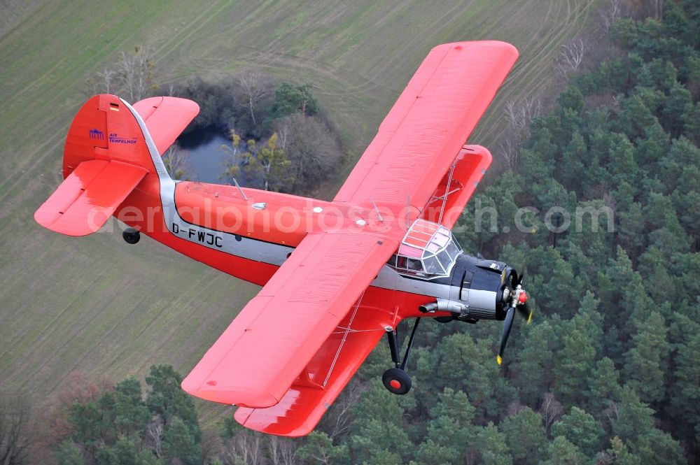 Melchow from the bird's eye view: Antonow AN-2 with of Kennung D-FWJC Aircraft in flight over the airspace in Melchow in the state Brandenburg, Germany