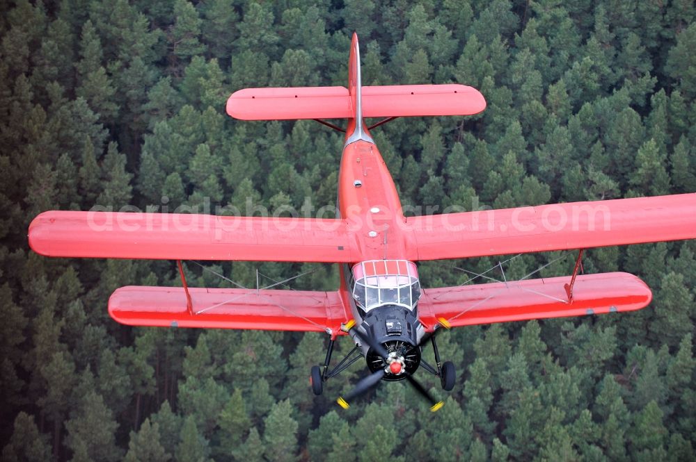 Melchow from the bird's eye view: Antonow AN-2 with of Kennung D-FWJC Aircraft in flight over the airspace in Melchow in the state Brandenburg, Germany