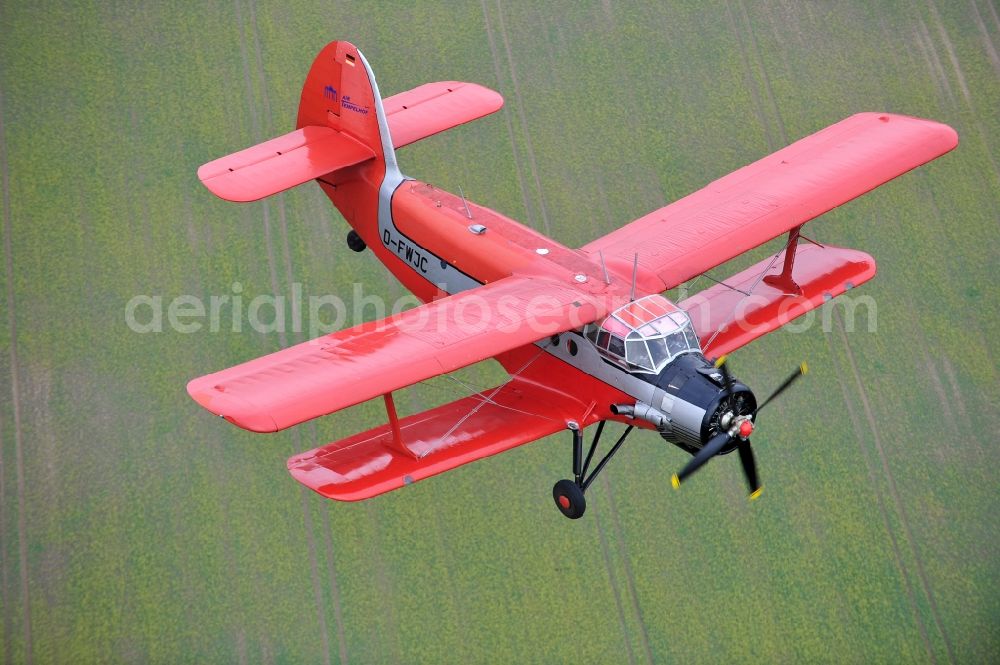 Melchow from the bird's eye view: Antonow AN-2 with of Kennung D-FWJC Aircraft in flight over the airspace in Melchow in the state Brandenburg, Germany