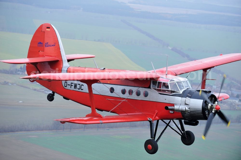 Melchow from the bird's eye view: Antonow AN-2 with of Kennung D-FWJC Aircraft in flight over the airspace in Melchow in the state Brandenburg, Germany