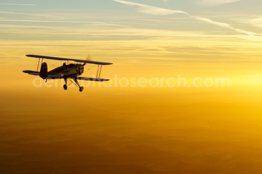 Aerial photograph Kranenburg - Aircraft Buecker 131 in flight over the airspace in Kranenburg in the state of Lower Saxony, Germany. The Buecker Bue 131 Jungmann was the first aircraft of the aircraft manufacturer Buecker Flugzeugbau