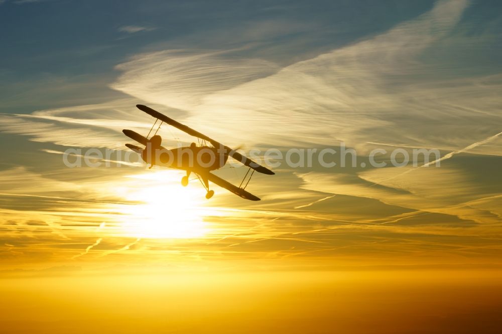 Kranenburg from the bird's eye view: Aircraft Buecker 131 in flight over the airspace in Kranenburg in the state of Lower Saxony, Germany. The Buecker Bue 131 Jungmann was the first aircraft of the aircraft manufacturer Buecker Flugzeugbau