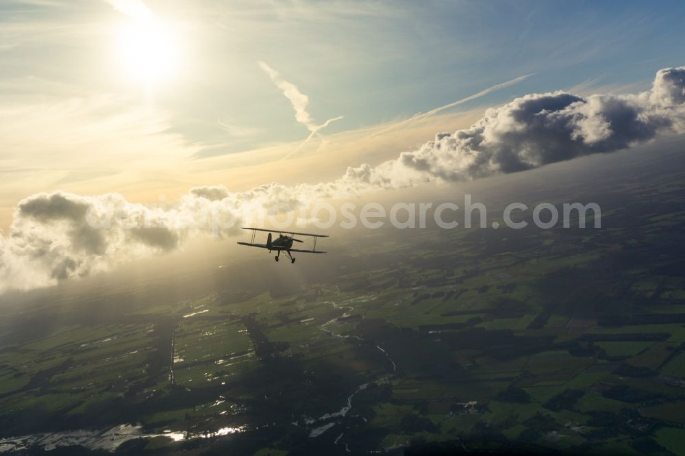 Bremervörde from above - Historical aircraft and bi-plane Buecker 131 Jungmann in flight over the airspace in Bremervoerde in the state Lower Saxony, Germany