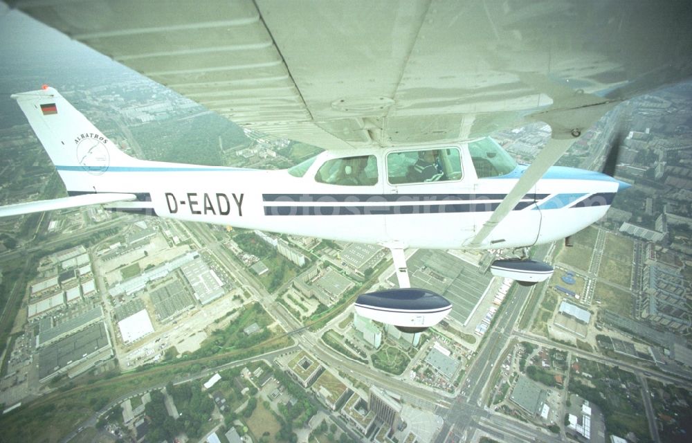 Berlin from the bird's eye view: Cessna 172 with the call sign D-EADY Aircraft in flight over the airspace in Berlin, Germany