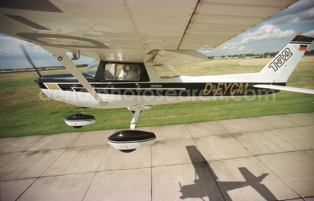 Strausberg from the bird's eye view: Airplane Cessna 152 with the registration D-EYCM taking off from the airfield in Strausberg in the state Brandenburg, Germany