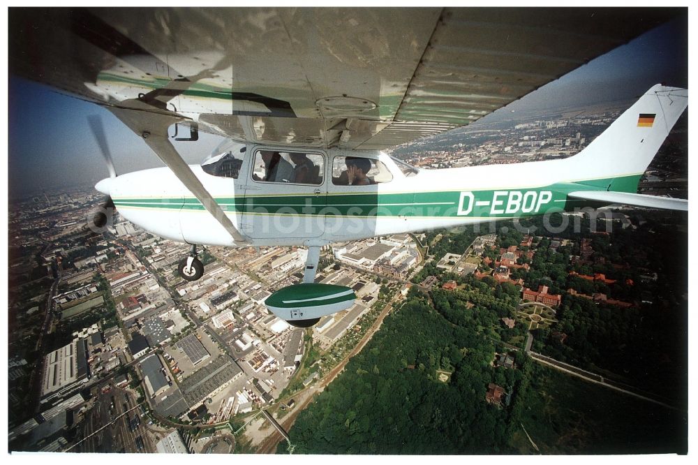 Aerial photograph Berlin - Cessna 172 with the identifier D-EBOP Aircraft in flight over the airspace in the district Lichtenberg in Berlin, Germany