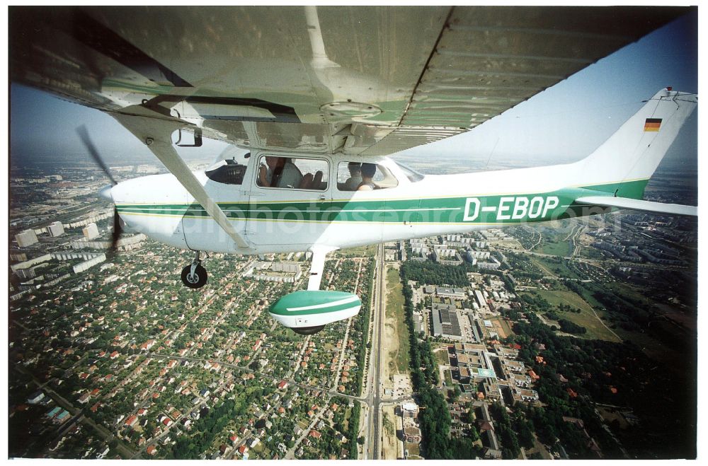 Aerial image Berlin - Cessna 172 with the identifier D-EBOB Aircraft in flight over the airspace in the district Lichtenberg in Berlin, Germany