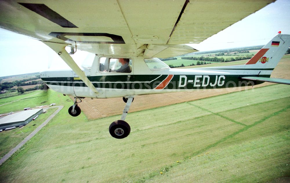 Aerial image Paulinenaue - Cessna 150 with the identifier D-EDJG Aircraft in flight over the airspace on street Lindholzfarm in the district Selbelang in Paulinenaue in the state Brandenburg, Germany