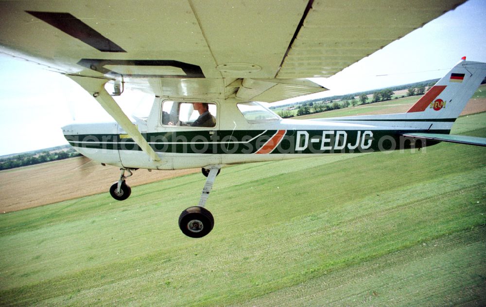 Aerial photograph Paulinenaue - Cessna 150 with the identifier D-EDJG Aircraft in flight over the airspace on street Lindholzfarm in the district Selbelang in Paulinenaue in the state Brandenburg, Germany