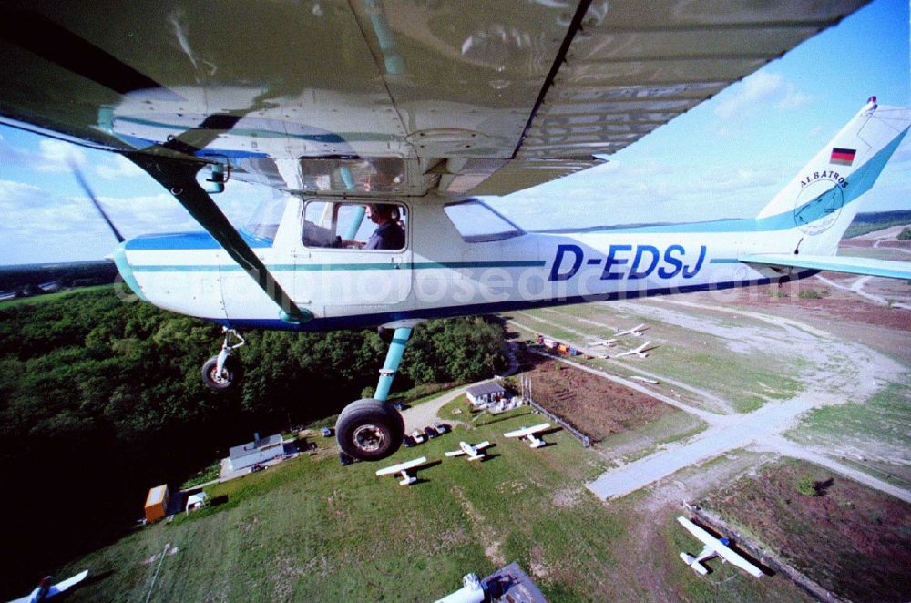 Aerial photograph Saarmund - Cessna 152 with the identifier D-EDSJ Aircraft in flight over the airspace in Saarmund in the state Brandenburg, Germany