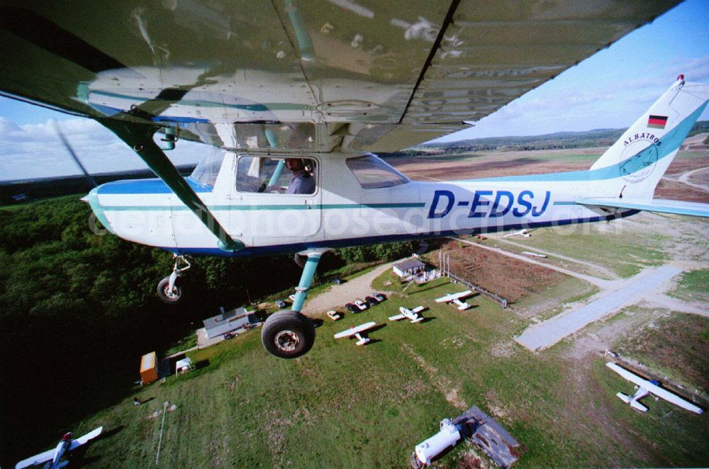 Saarmund from the bird's eye view: Cessna 152 with the identifier D-EDSJ Aircraft in flight over the airspace in the district Nuthetal in Saarmund in the state Brandenburg, Germany