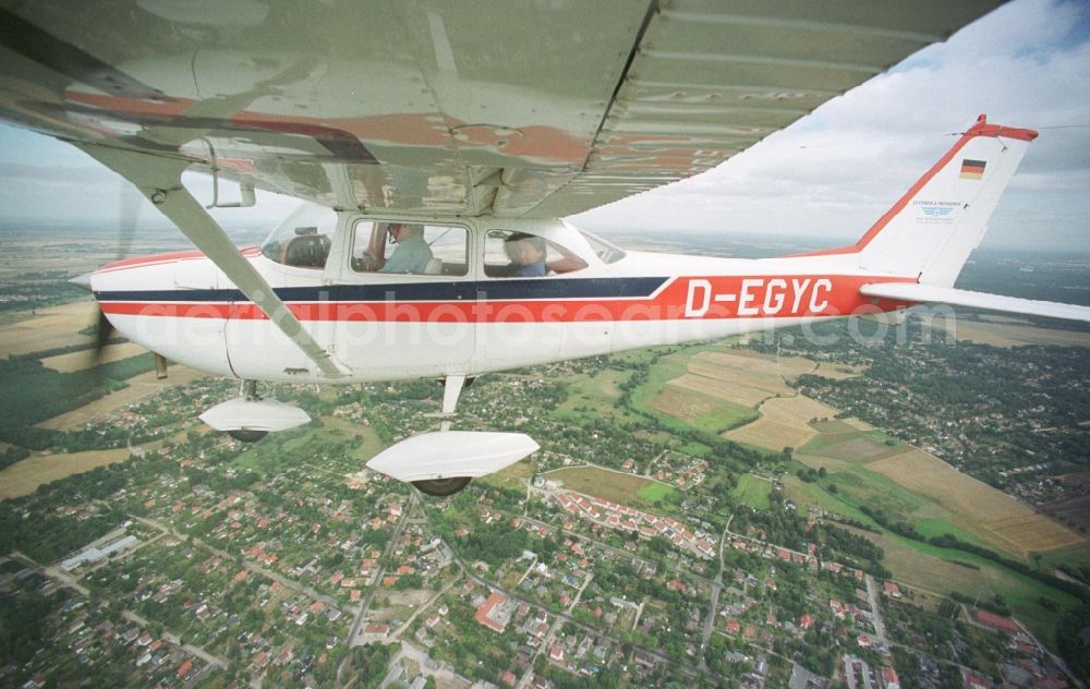 Fredersdorf from above - Cessna 172 with the identifier D-EGYC Aircraft in flight over the airspace in Fredersdorf in the state Brandenburg, Germany