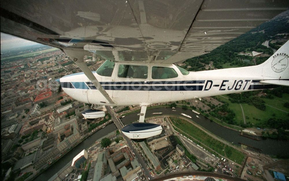 Berlin from the bird's eye view: Cessna 172 with the identifier D-EJGT Aircraft in flight over the airspace in the district Tiergarten in Berlin, Germany