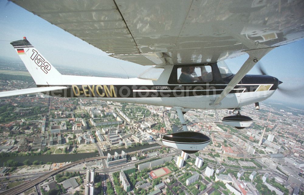 Aerial photograph Berlin - Cessna 152 with the identifier D-EYCM Aircraft in flight over the airspace on place Alexanderplatz in the district Mitte in Berlin, Germany