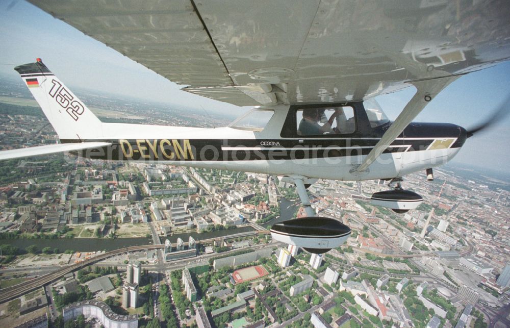 Berlin from above - Cessna 152 with the identifier D-EYCM Aircraft in flight over the airspace on place Alexanderplatz in the district Mitte in Berlin, Germany