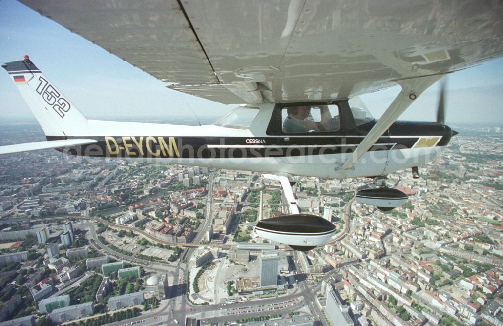 Aerial image Berlin - Cessna 152 with the identifier D-EYCM Aircraft in flight over the airspace on place Alexanderplatz in the district Mitte in Berlin, Germany