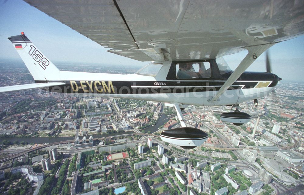 Aerial photograph Berlin - Cessna 152 with the identifier D-EYCM Aircraft in flight over the airspace on place Alexanderplatz in the district Mitte in Berlin, Germany