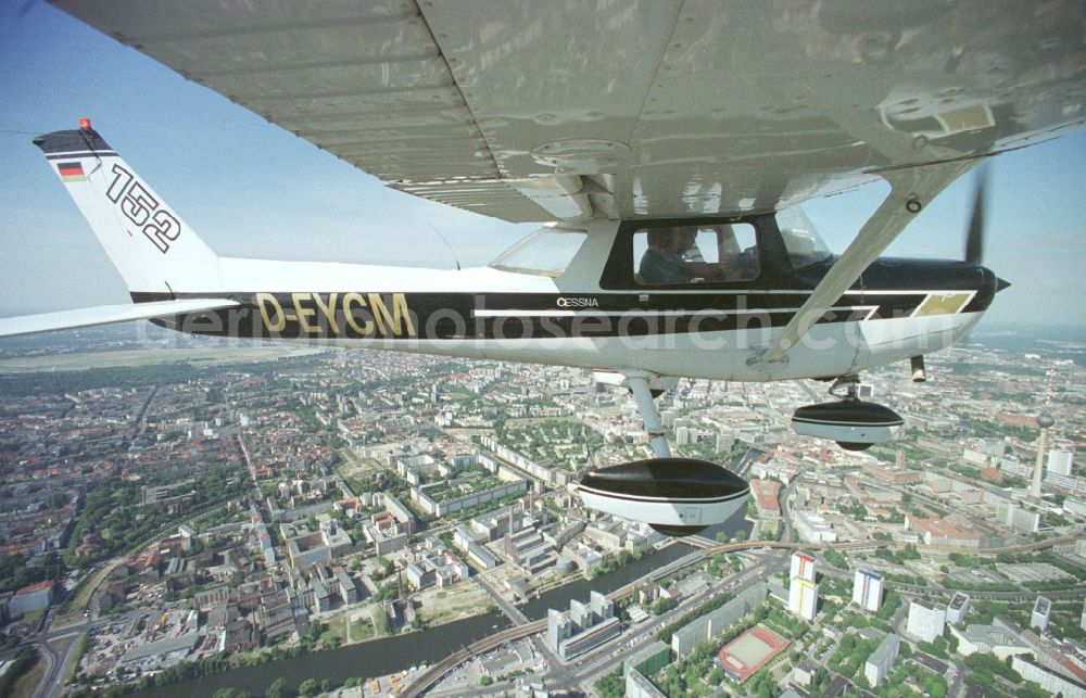 Berlin from above - Cessna 152 with the identifier D-EYCM Aircraft in flight over the airspace on place Alexanderplatz in the district Mitte in Berlin, Germany