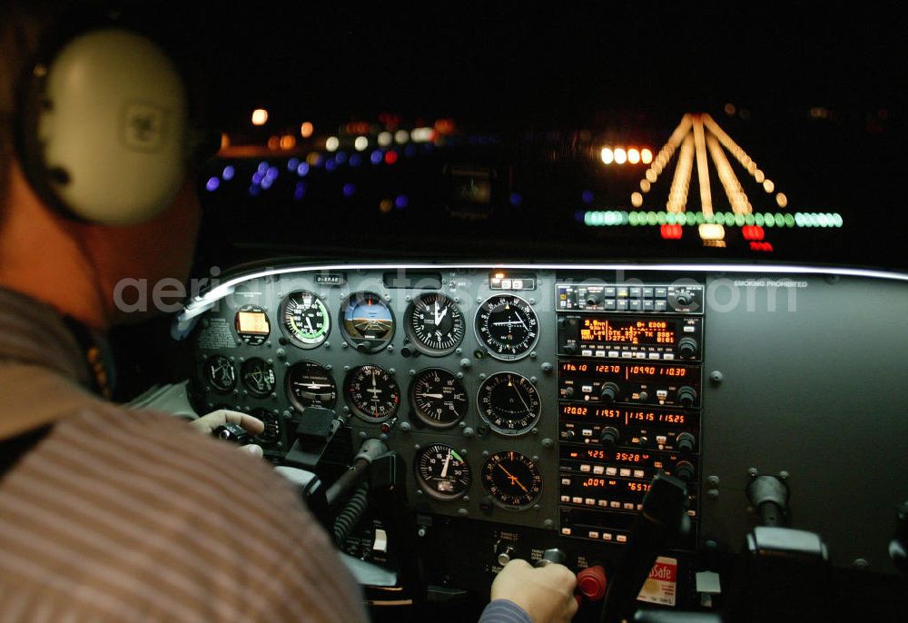 Aerial image Schönefeld - Nachtaufnahme vom Cockpit des Flugzeug / Kleinflugzeug vom Typ Cessna 172 während eines Anfluges auf den Flughafen Berlin-Schönefeld bei Nacht. View of the cockpit of the airplane / small aircraft during an approach to the Schoenefeld airport at night.