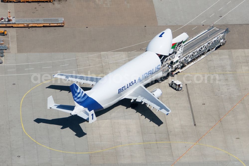 Hamburg from above - The process of discharging an aircraft of the type A300-600ST (Beluga) on Hamburg Finkenwerder Airport. Operator of the aircraft is the Airbus Group