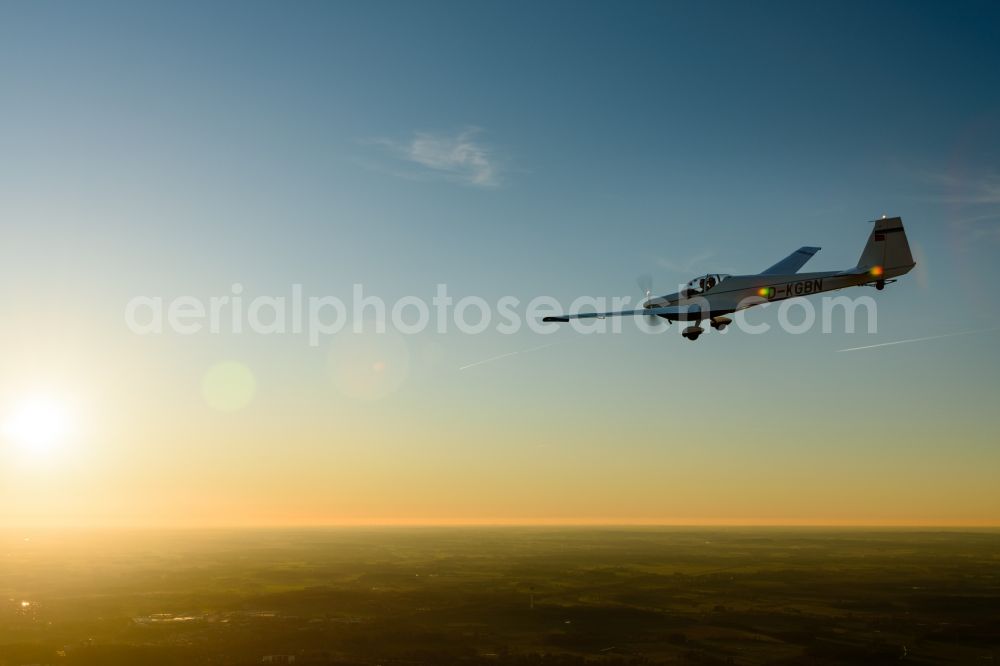 Stade from above - And Motorsegler SF 25 Aircraft in flight while sunset over the airspace in Stade in the state Lower Saxony, Germany