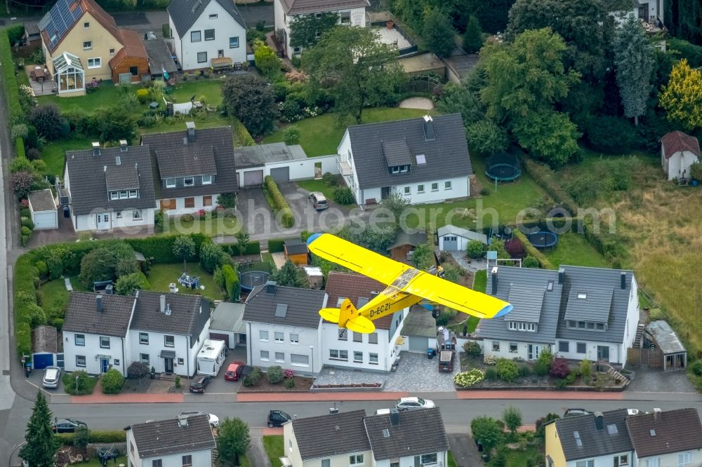 Schwelm from the bird's eye view: Piper J-3C-85 Cub D-ECZI Aircraft in flight over the airspace in Schwelm in the state North Rhine-Westphalia, Germany