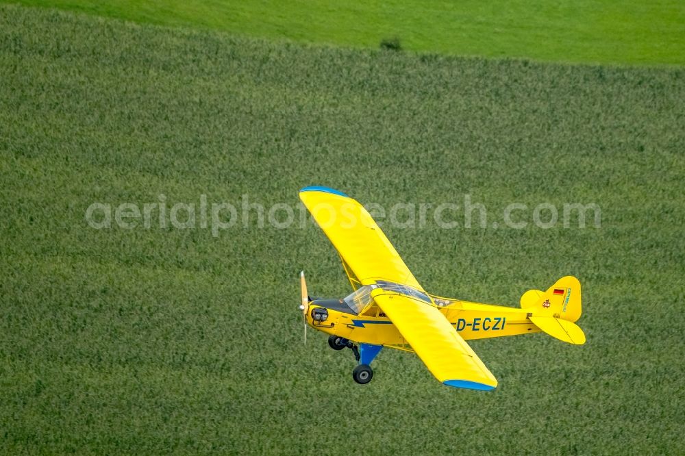 Schwelm from the bird's eye view: Piper J-3C-85 Cub D-ECZI Aircraft in flight over the airspace in Schwelm in the state North Rhine-Westphalia, Germany