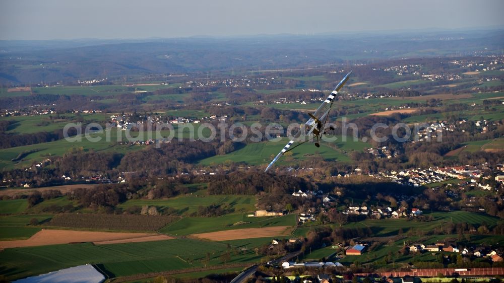 Königswinter from the bird's eye view: Airplane Piper L-4 in the airspace of Koenigswinter in the state North Rhine-Westphalia, Germany