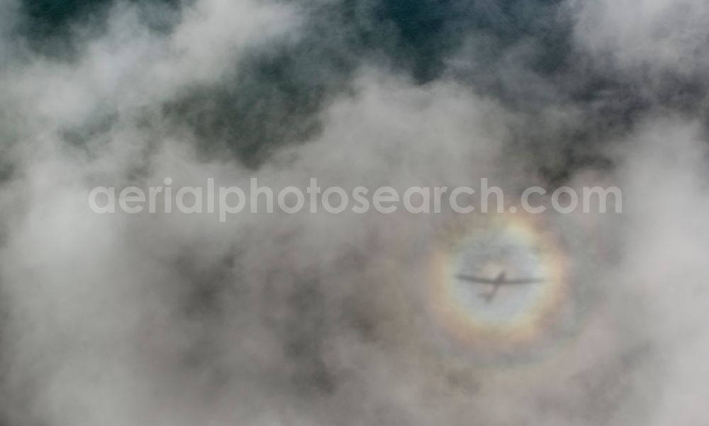 Putgarten from the bird's eye view: Plane silhouette in flight over cloud-shrouded landscape of the Baltic Sea coast of Cape Arkona on the island of Rügen in Mecklenburg-Western Pomerania