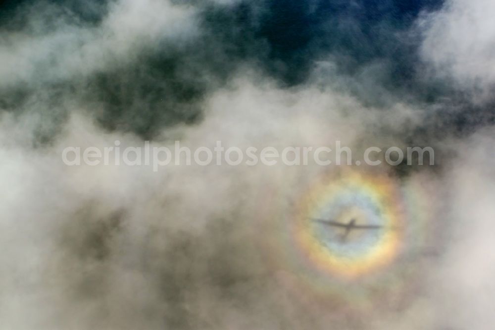 Aerial image Putgarten - Plane silhouette in flight over cloud-shrouded landscape of the Baltic Sea coast of Cape Arkona on the island of Rügen in Mecklenburg-Western Pomerania