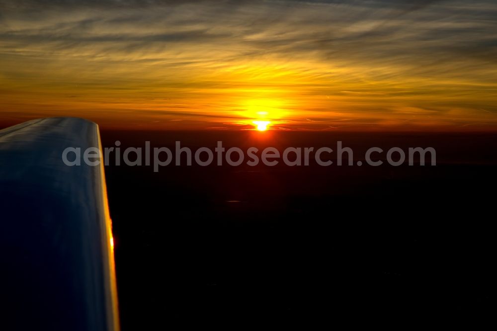 Dortmund from above - Wing a motor glider on the sunset-horizon Aircraft in flight over the airspace in Dortmund in the state North Rhine-Westphalia