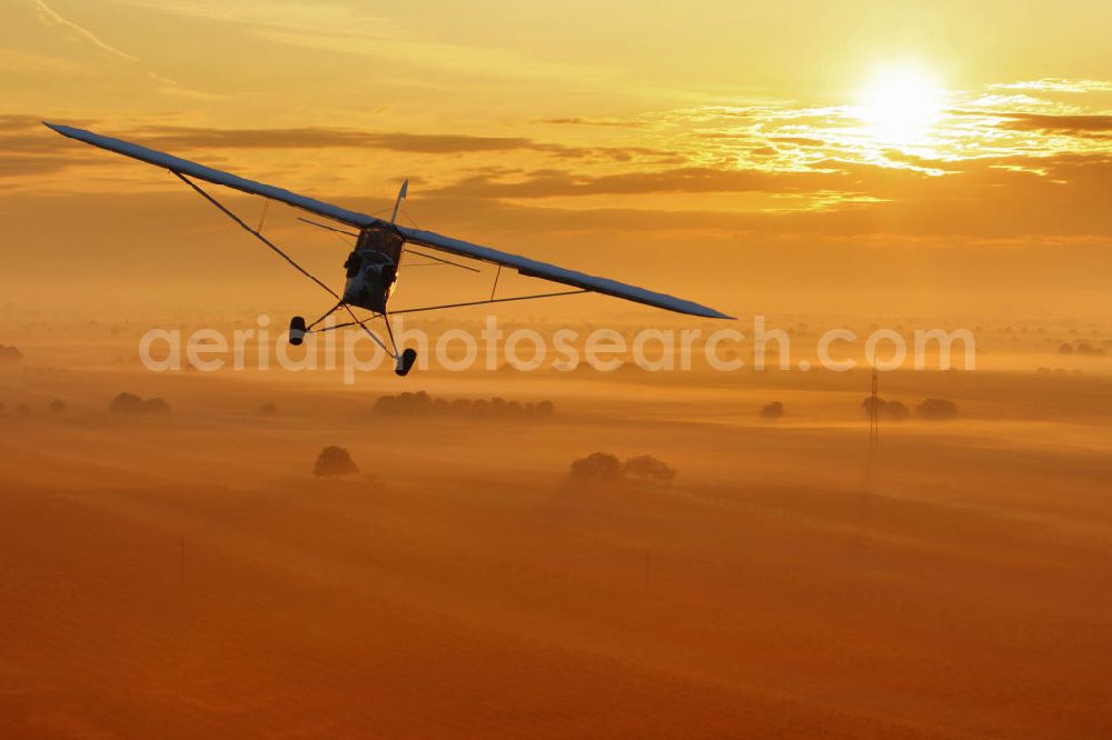 Aerial photograph Großwarasdorf - Flugzeug / Kleinflugzeug vom Typ Piper J-3 Cup und Sonnenuntergang nahe dem Flugplatz Großwarasdorf in Österreich. Small Aircraft and sunset near by the Grosswarasdorf airfield in Austria.