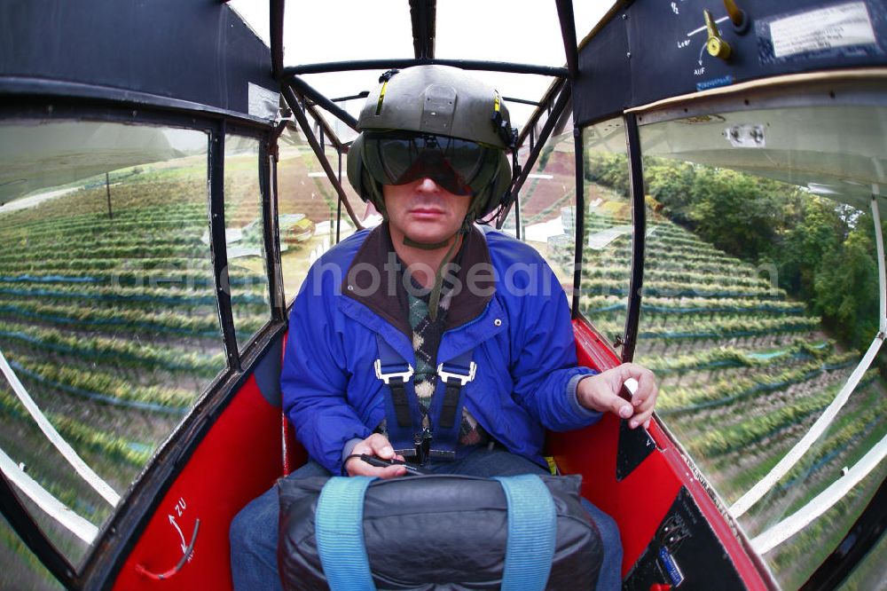 Aerial image Großwarasdorf - Pilot im Flugzeug / Kleinflugzeug vom Typ Piper J-3 Cup mit der Kennung OE-ABE fliegt über Weinreben nahe dem Flugplatz Großwarasdorf in Österreich. Pilot an a small Aircraft flies over grapevines near by the Grosswarasdorf airfield in Austria.