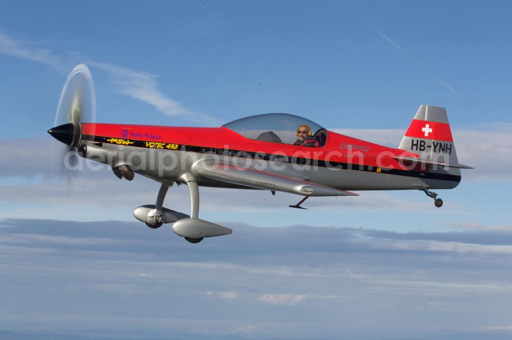 Birrfeld from the bird's eye view: Kunstflugzeug / Flugzeug vom Typ VOTEC 452 mit der schweizer Kennung HB-YNH nahe dem Flugplatz Birrfeld / Schweiz. Aerobatic aircraft near by the Birrfeld airfield in Switzerland.