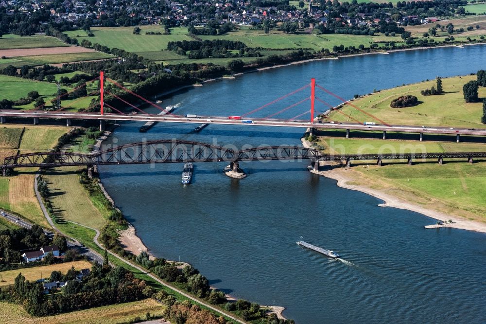 Duisburg from the bird's eye view: River - bridge construction - A42 highway bridge and railway bridge over the Rhine in Duisburg in North Rhine-Westphalia