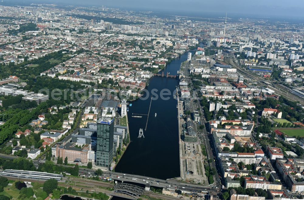 Berlin from above - River - bridge structure Else bridge over the Spree in Berlin. Eyecatcher is the sculpture Molecule Man by Jonathan Borofsky whose three figures symbolizes the coming together of the three districts Treptow, Kreuzberg and Friedrichshain