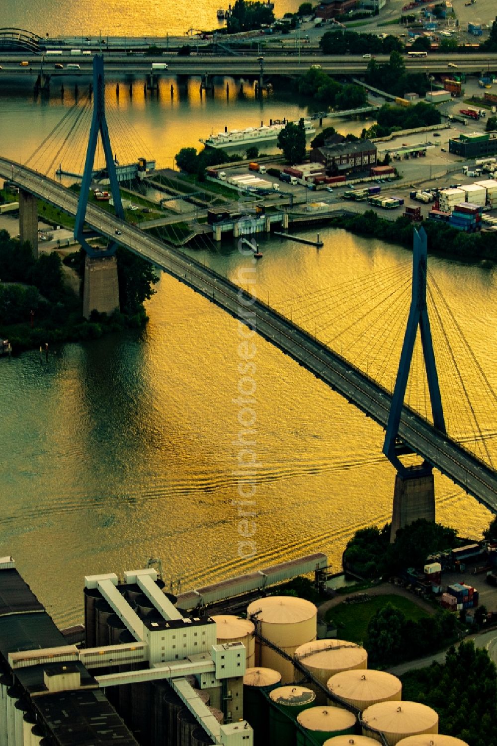 Hamburg from above - River bridge structure of a cable-stayed bridge Koehlbrandbruecke in the sunset over the Rugenberg harbor in the Steinwerder district in Hamburg, Germany