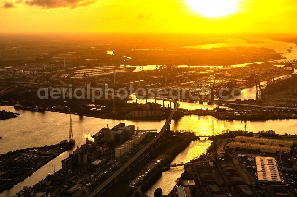Aerial photograph Hamburg - River bridge structure of a cable-stayed bridge Koehlbrandbruecke in the sunset over the Rugenberg harbor in the Steinwerder district in Hamburg, Germany
