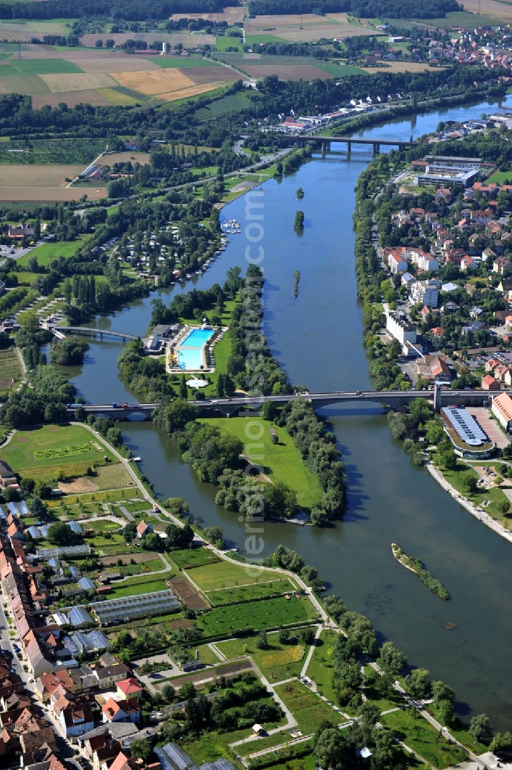 Kitzingen from above - View from north along the Main river with the Konrad-Adenauer-Bridge and the open-air bath on the Mondsee Island and South Bridge in Kitzingen in the state Bavaria