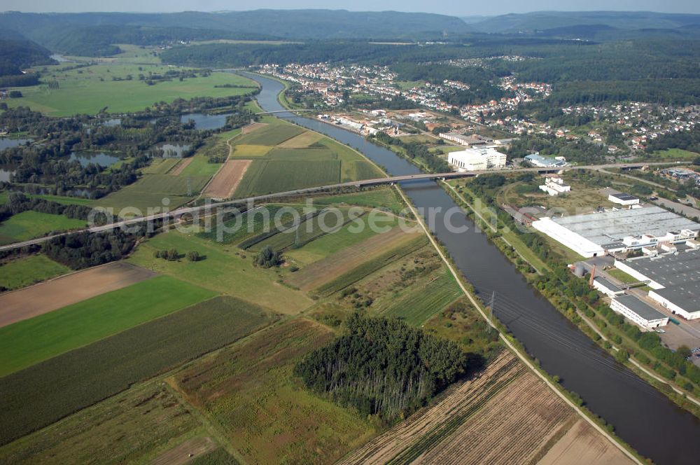 Besseringen Stadt Merzig from the bird's eye view: Blick aus Südost über den Fluss Saar mit Brücke. Auf der linken Uferseite bei Schwemlingen liegen die Sargauer Wiesen mit Weidenbestand, Pappelreihe sowie Brachflächen und auf der rechten Uferseite erstreckt sich das Gewerbegebiet Wiesenhof.