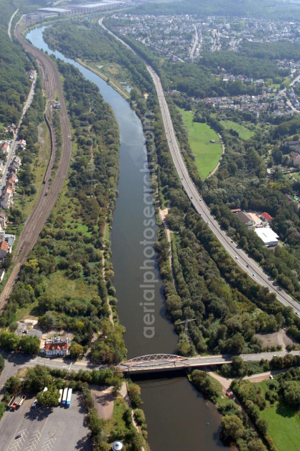 Aerial photograph Bous - Blick aus Westen entlang der Saar bei Bous im Saarland mit der Straßenbrücke zwischen Bous und Wadgassen. Am linken Saarufer erstreckt sich die Autobahn 620 vorbei an Wadgassen. Am rechten Ufer erstrecken sich Gleise. View from west along the Saar river.