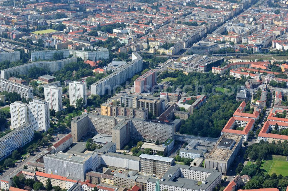 Berlin Lichtenberg from above - Blick auf die Forschungs- und Gedenkstätte Normannenstraße / Ruschestrasse, der ehemaligen Zentrale des Ministeriums für Staatssicherheit ( MfS ). Sie ist eine Forschungs- und Gedenkstätte zum politischen System der DDR. Die Ausstellung umfasst die Amts- und Arbeitsräume des ehemaligen Ministers für Staatssicherheit Erich Mielke. Träger ist der Verein Antistalinistische Aktion Berlin-Normannenstraße e. V. (ASTAK), die im Sommer 1990 von Bürgerrechtlern in Berlin gegründet wurde. Ihr Ziel ist die Förderung des Aufbaus der Gedenkstätte als Zentrum zur Sammlung, Bewahrung, Dokumentation, Aufarbeitung und Ausstellung von Sachzeugnissen sowie themenbezogener Forschungsarbeit zur DDR. View of the former headquarters of the Ministry for State Security (Stasi) of the GDR.