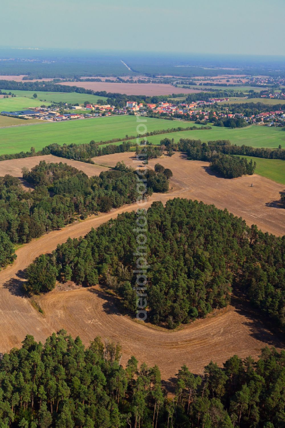 Aerial image Großkmehlen - Forest areas in with harvested grain fields in Grosskmehlen in the state Brandenburg, Germany