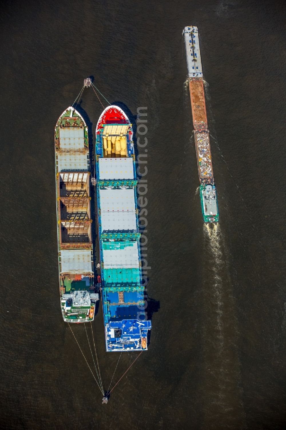 Hamburg from the bird's eye view: Cargo ships and bulk carriers moored in the harbor der Elbe in Hamburg in Germany