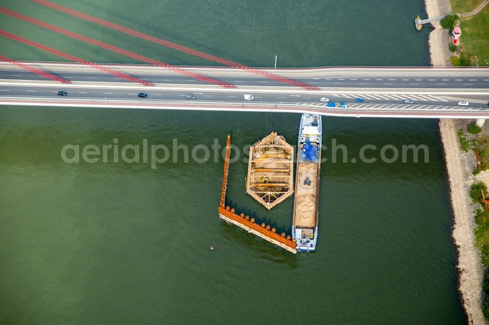 Wesel from the bird's eye view: Cargo ships and bulk carriers on the inland shipping waterway at the construction site near the new bridge of the Rhine in Wesel in the state North Rhine-Westphalia