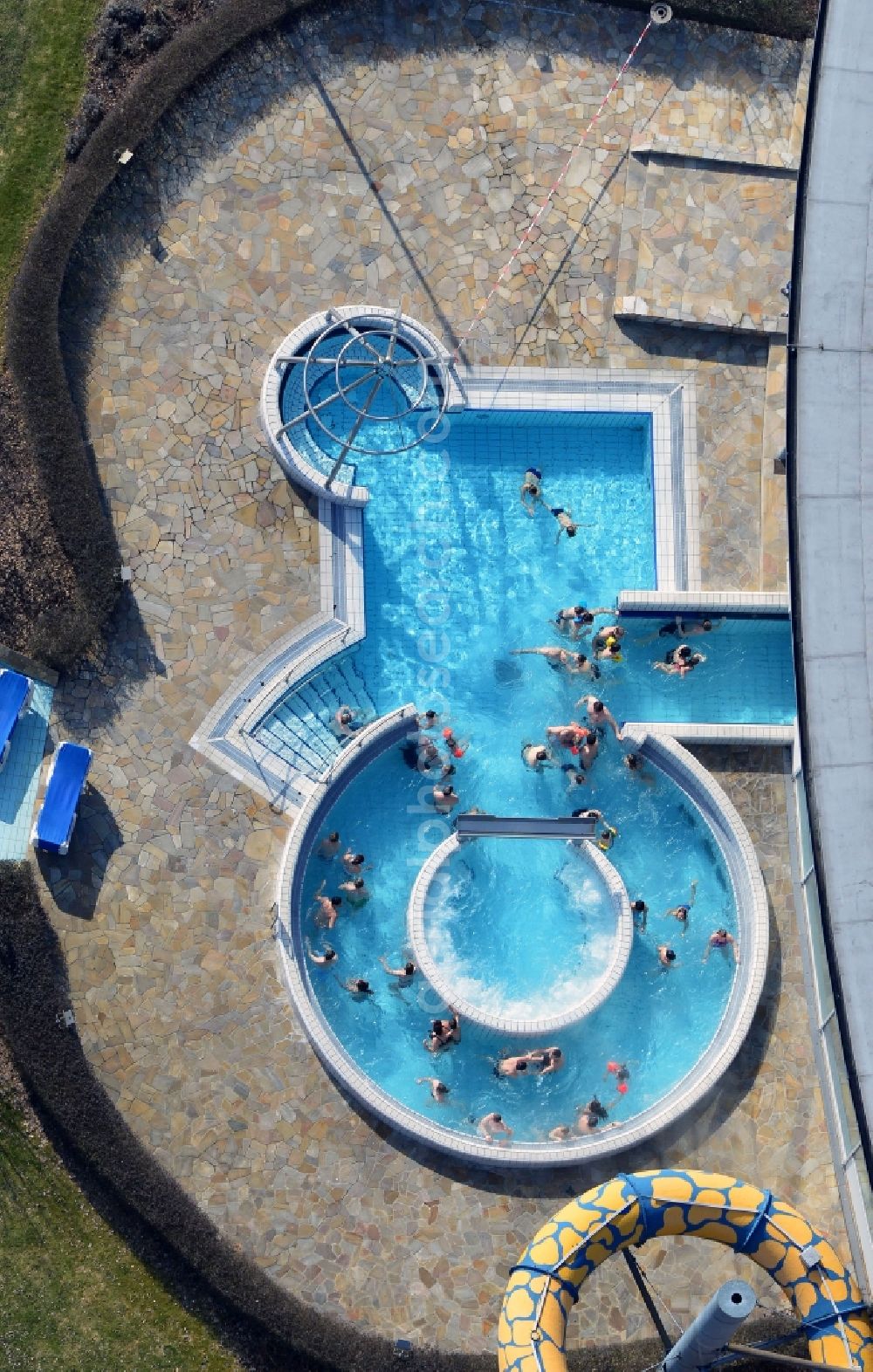 Aerial image Oranienburg - Outdoor swimming pool under the sun at the swimming TOWER Experience City Oranienburg in Brandenburg. The TURM Experience City in Oranienburg is a swimming pool with a spa area. In addition to the large water park, there are also a variety of other sport activities