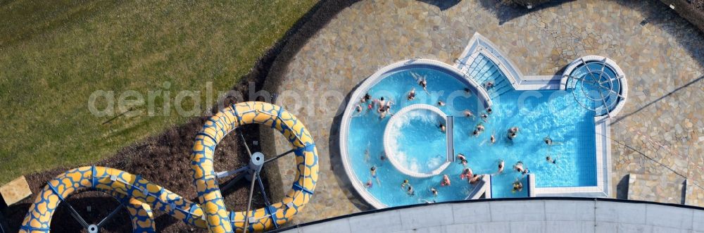 Oranienburg from the bird's eye view: Outdoor swimming pool under the sun at the swimming TOWER Experience City Oranienburg in Brandenburg. The TURM Experience City in Oranienburg is a swimming pool with a spa area. In addition to the large water park, there are also a variety of other sport activities