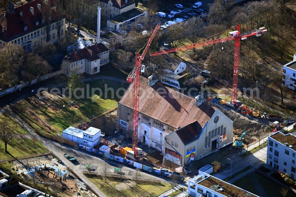 München from above - Freestanding supported facade on the construction site for gutting and renovation and restoration of the historic building Heizwerk Schwabing on street Mildred-Scheel-Bogen in the district Schwabing in Munich in the state Bavaria, Germany